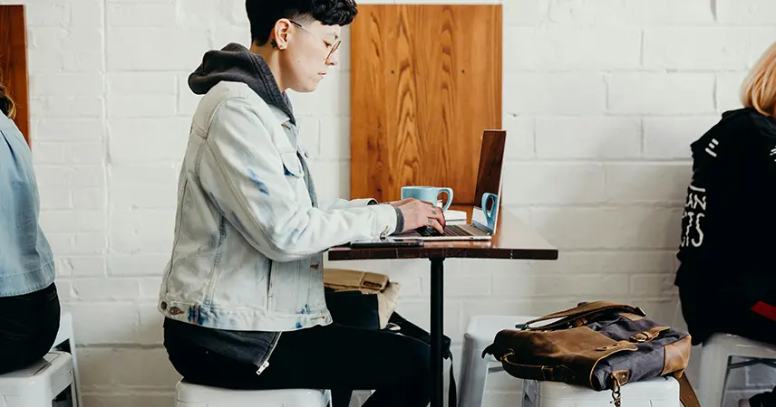 person in cafe with laptop